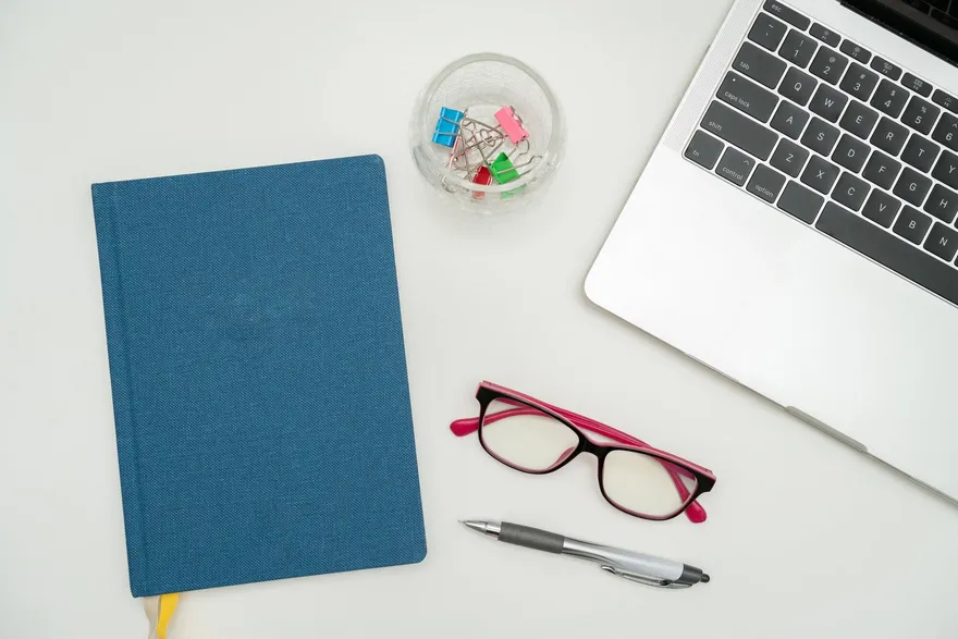 Organized desk with a navy notebook, planning an LLC's business credit