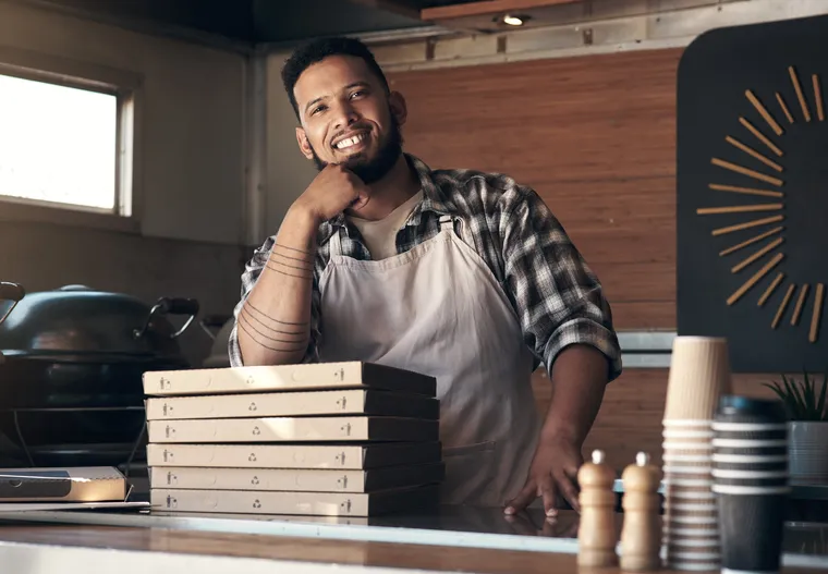 Food truck owner smiling at the service window