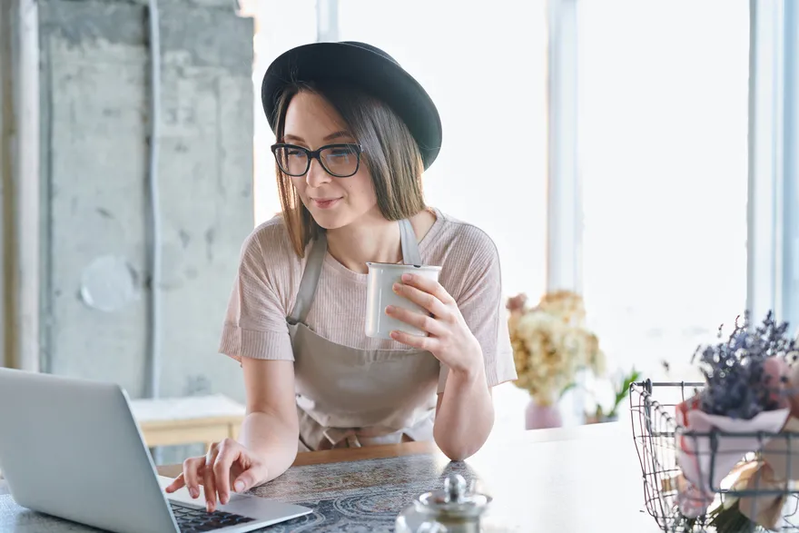 Small business owner reviewing finances on a laptop